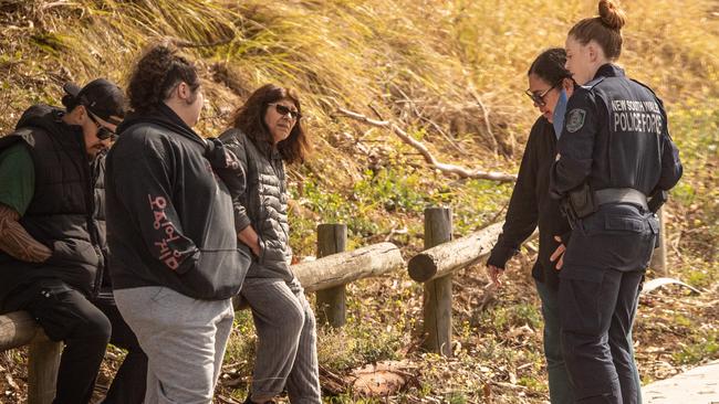 Angelina Kauffman (standing next to police officer) and other family members) at the crash scene. Picture: Julian Andrews