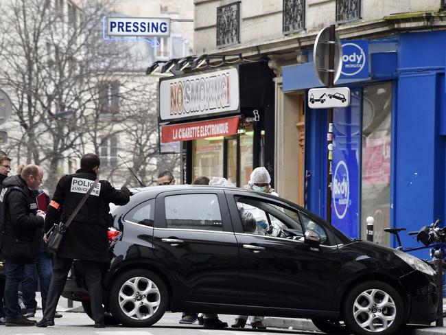 Investigation ... French police and forensic experts examine the car used by armed gunmen who stormed the Paris offices of Charlie Hebdo. Picture: AFP/Getty Images