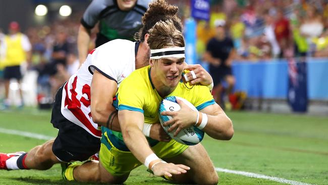 GOLD COAST, QUEENSLAND - APRIL 14:  Charlie Taylor of Australia is tackled by  Michael Ellery of England on his way to score a try during Rugby Sevens on day 10 of the Gold Coast 2018 Commonwealth Games at Robina Stadium on April 14, 2018 on the Gold Coast, Australia.  (Photo by Mark Kolbe/Getty Images)