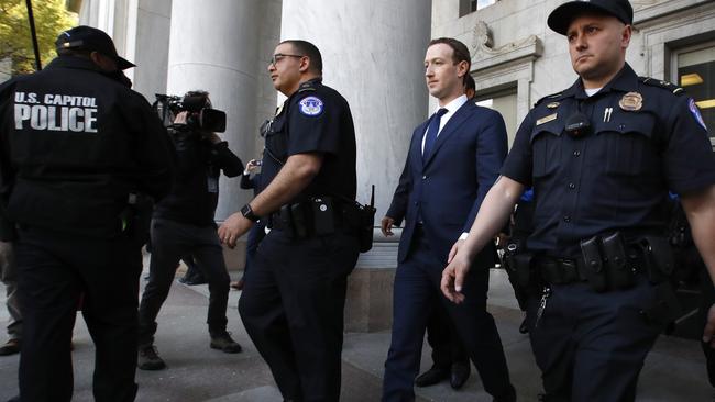 Mark Zuckerberg, second from right, leaves the Rayburn House Office Building after testifying before a House Energy and Commerce hearing on Capitol Hill. Picture: AP.