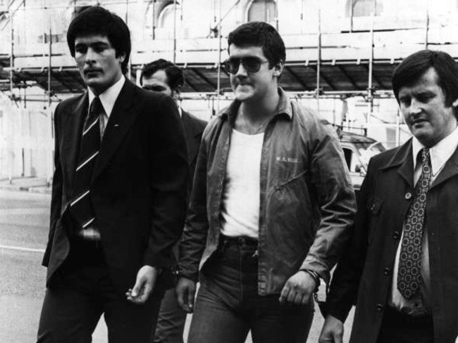 1979: Mark 'Chopper' Read is led from Russell Street Police Headquarters in Melbourne to the City Watchhouse after being charged with seven offences following his attempt to kidnap a judge at the County Court. File picture