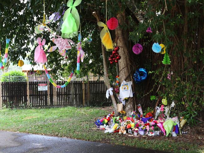 Floral tributes left at a temporary memorial in Murray Street park, Manoora, adjacent to where eight children were stabbed to death two week's ago. Picture: Brendan Radke.