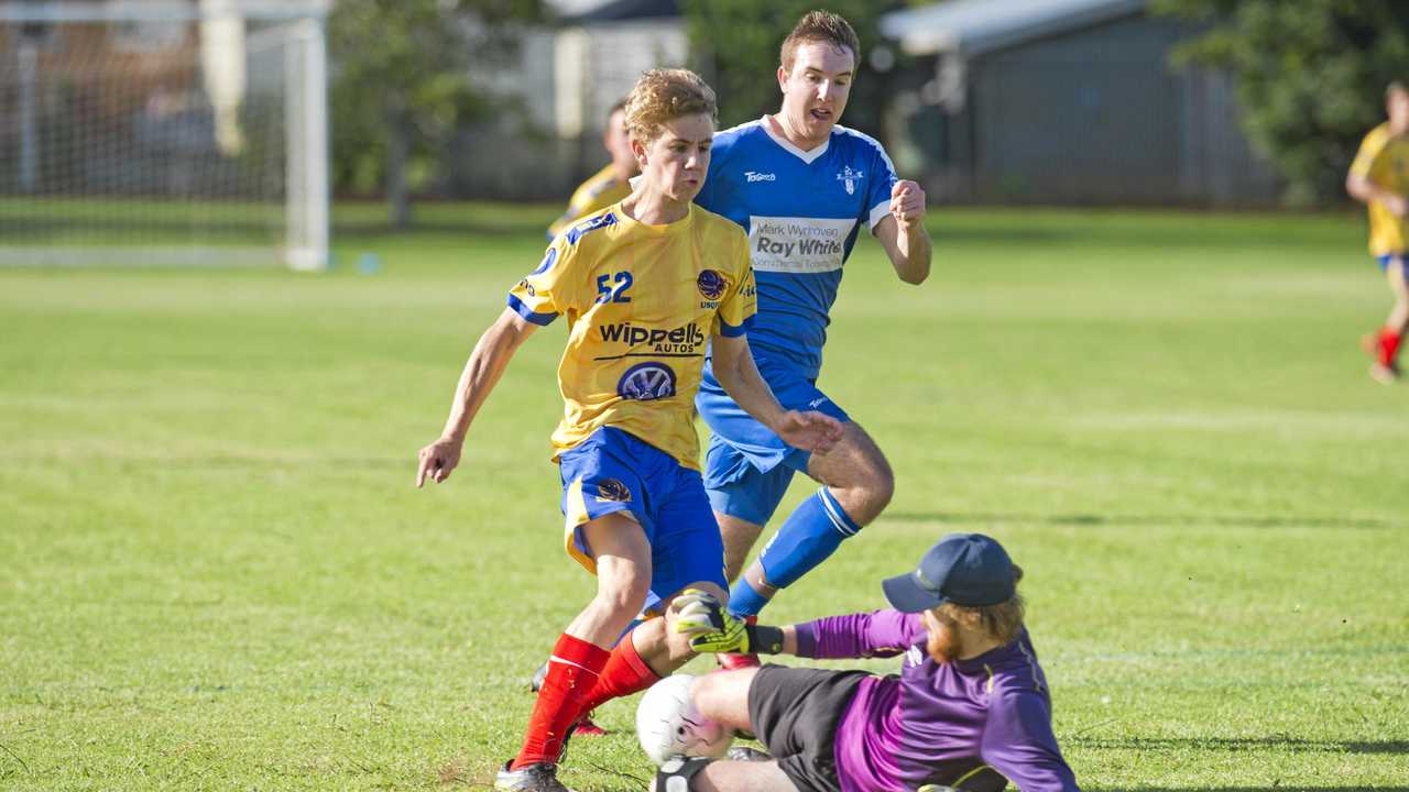 HARD PASS: Rockville keeper Hayden Chalmers saves at the feet of USQ attacker Cormac McCarthy. Chalmers shone for Rovers in their 2-1 FFA Cup loss to USQ at the weekend. Picture: Nev Madsen