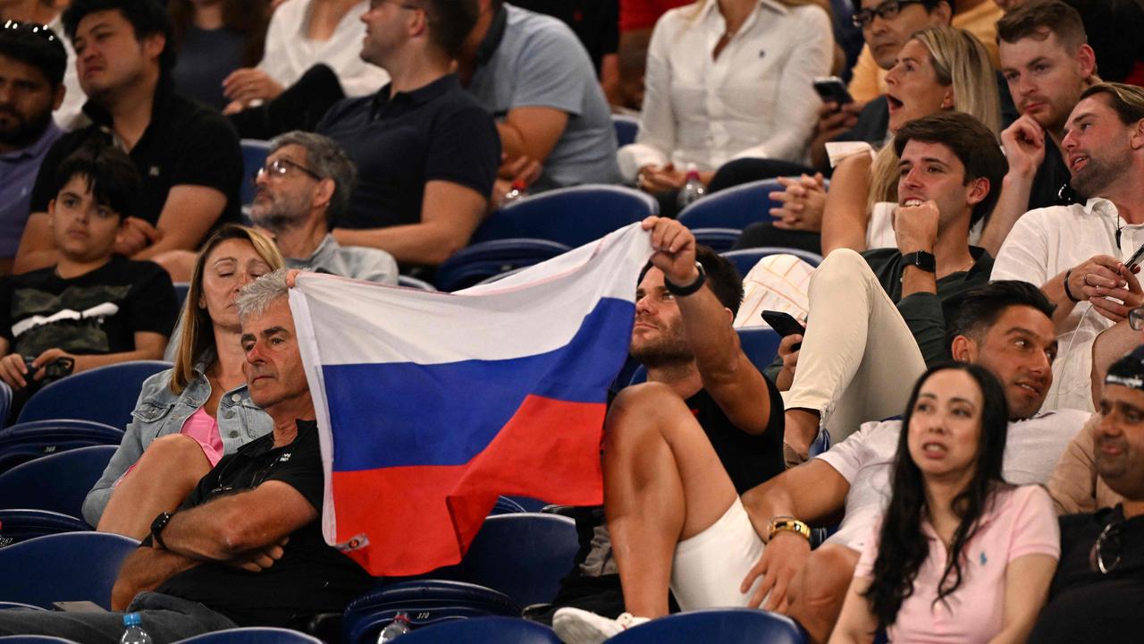 A supporter holds a Russian flag during the men's singles match between Marcos Giron of the US and Russia's Daniil Medvedev on day one of the Australian Open. Picture: William West/ AFP