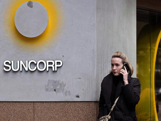 A pedestrian walks past a Suncorp Bank branch in Melbourne on July 18, 2022. - Australian banking giant ANZ announced on July 18 a 3.3 billion USD deal to swallow regional lender Suncorp Bank -- one of the biggest takeovers in the sector for more than a decade. (Photo by William WEST / AFP)