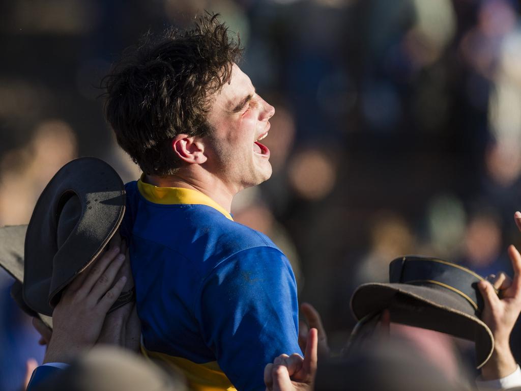 Grammar captain George Griffiths is lifted by students in celebration.