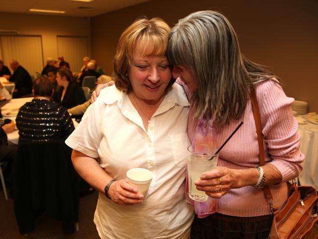 Peter Hofmann’s sister, Tricia is consoled by friend Diann Relf at the wake.