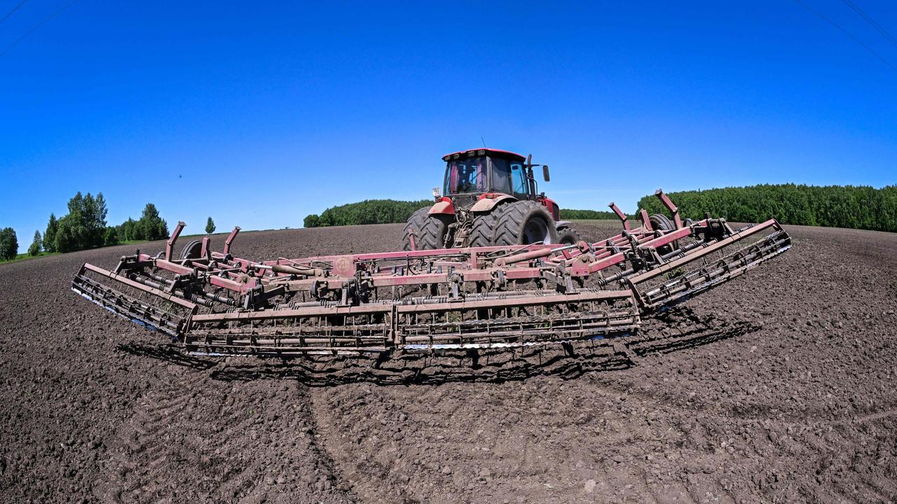 A tractor towes a harrow on the field of Chyorny Khleb ("Black Bread") enterprise in the village of Khatmanovo, some 150 kilometres outside Moscow on June 7. -Yevgeny Shifanov, co-owner, says his business has felt the sting of Western sanctions and he is no longer able to sell his grain to Europe. Picture: Yuri KADOBNOV / AFP