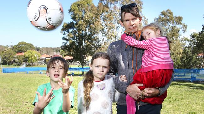 Luke Buckle poses with his kids Darcy Buckle (8), Gracie Buckle (10), Azalea Buckle (5) at Ashbury Peace Park in 2018.