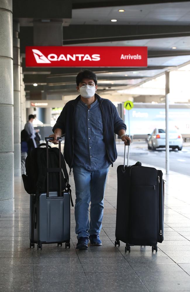 A passenger arrives at Sydney Airport wearing a mask. Picture: David Swift/NCA NewsWire