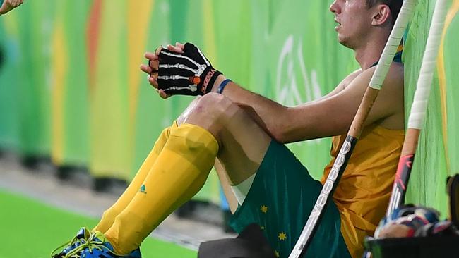 Australia's Simon Orchard sits on the field at the end of the men's quarterfinal field hockey Netherlands vs Australia match of the Rio 2016 Olympics Games at the Olympic Hockey Centre in Rio de Janeiro on August 14, 2016. / AFP PHOTO / MANAN VATSYAYANA