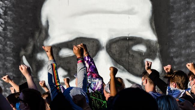 People raise their hands as they protest at the makeshift memorial in honour of George Floyd, in Minneapolis, Minnesota. Picture: AFP