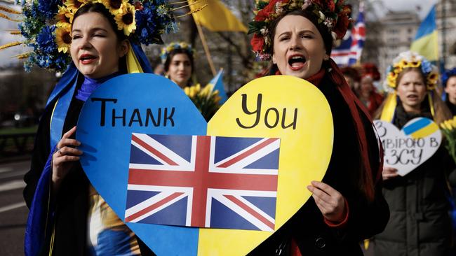 LONDON, ENGLAND - FEBRUARY 24: People with placards and Ukrainian flags participate in a march to mark 2 years since the beginning of the Russian invasion of Ukraine on February 24, 2024 in London, United Kingdom. Entering its third year, Russia's unyielding war on Ukraine has raised concerns about how long Western countries will continue providing weapons and other support to Kyiv. The supply of ammunition, arms, and manpower is now a critical factor in a conflict that has claimed over half a million casualties, and caused the widespread displacement of civilians.  (Photo by Dan Kitwood/Getty Images) *** BESTPIX ***