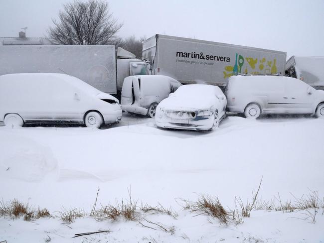 Several trucks and cars, covered with snow, stand deserted after a pileup on February 27, 2018 near Sjobo, southern Sweden. A Siberian cold front has sent temperatures plunging across much of Europe, leading to several deaths from exposure as snow carpeted cities and palm-lined beaches along the Mediterranean. Picture: AFP