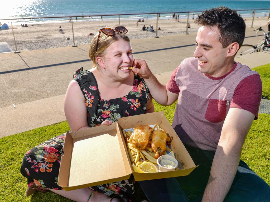 Kate Dicker and Daniel Korber enjoy fish and chips at Henley Square. Pic: Brenton Edwards