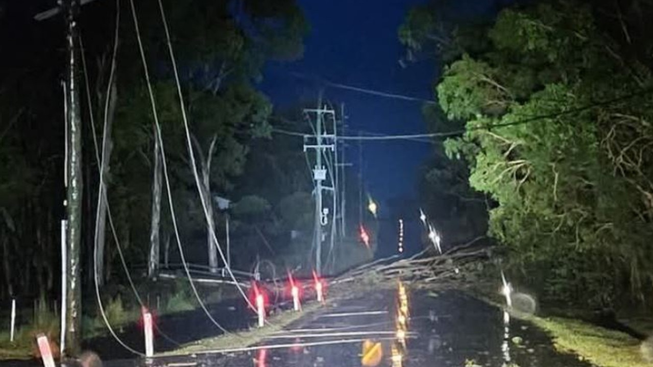 Giles Rd in Redland Bay has multiple powerlines down and trees blocking road.