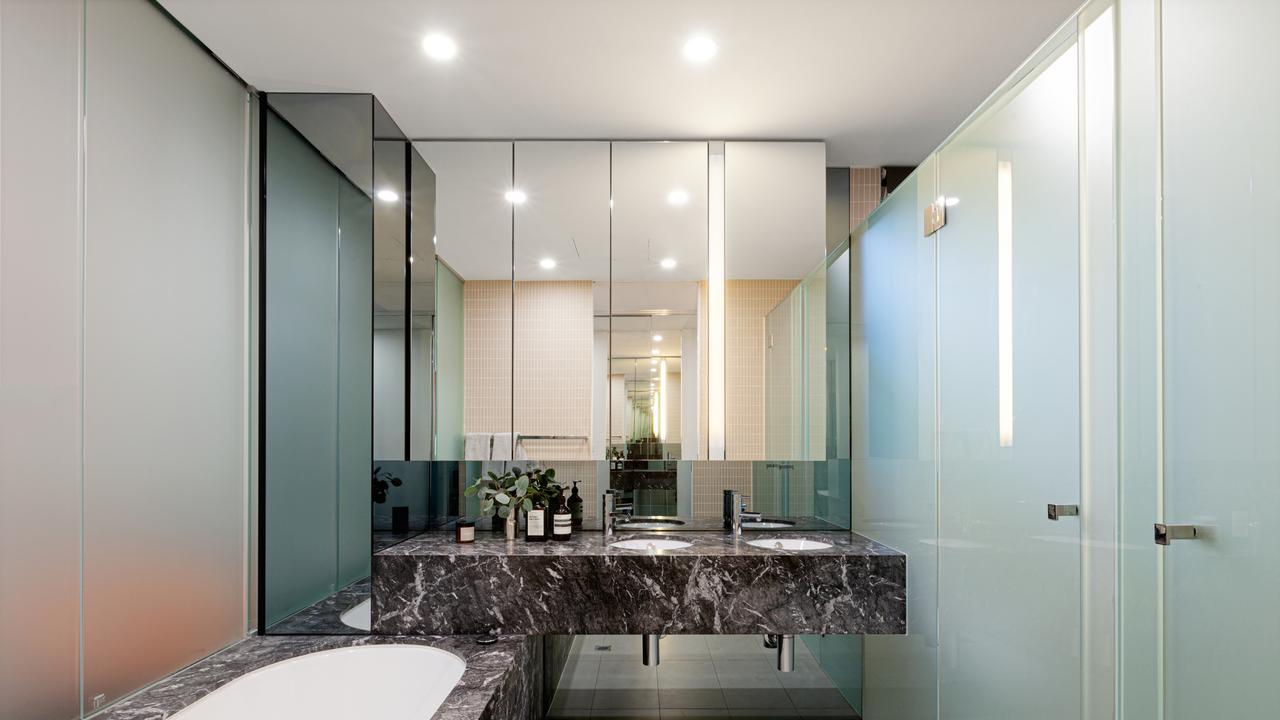 Marble-wrapped bathrooms throughout the penthouse add a luxe, spa-like feel to everyday living.
