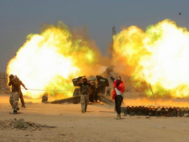 Iraqi security forces and allied Popular Mobilization forces fire artillery during fight against Islamic State militants in Fallujah, Iraq. Picture: AP / Anmar Khalil