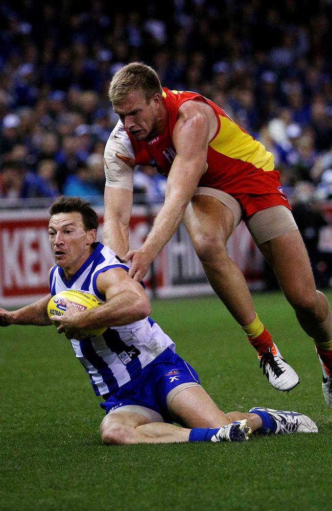 Where did he come from? Brent Harvey is run down by Sam Day. Picture: Colleen Petch