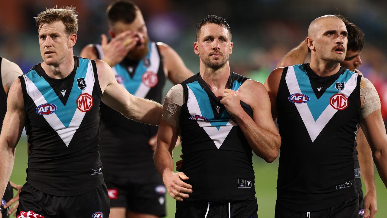 ADELAIDE, AUSTRALIA - SEPTEMBER 11: Tom Jonas, Travis Boak and Sam Powell-Pepper of the Power look dejected after losing the AFL Second Preliminary Final match between Port Adelaide Power and Western Bulldogs at Adelaide Oval on September 11, 2021 in Adelaide, Australia. (Photo by Daniel Kalisz/Getty Images)