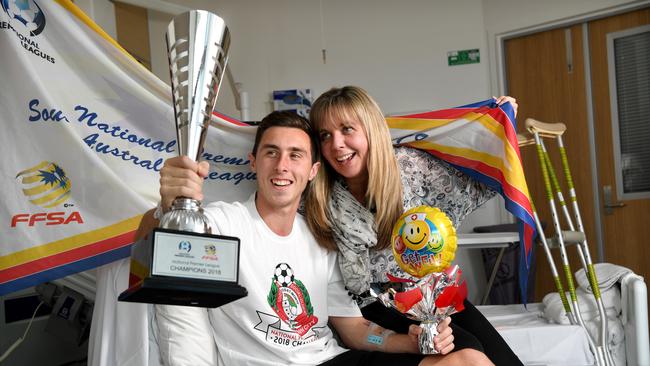 Campbelltown City playmaker Dion Kirk had to wait about 48 hours to get his hands on the club's latest trophy after he was rushed to hospital during the NPL grand final. He is pictured at the RAH with mum Tracey. Picture: Tricia Watkinson