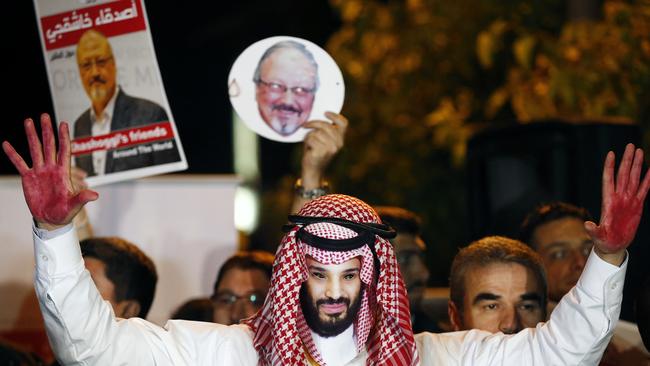 An activist wearing a mask depicting Saudi Crown Prince Mohammed bin Salman, holds up his hands painted with fake blood during a candlelight vigil for Saudi journalist Jamal Khashoggi outside Saudi Arabia's consulate in Istanbul. Picture: AP.