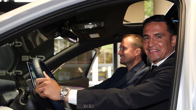 EV Direct chief executive Luke Todd (left) and hands on investor, Australian soccer great Tim Cahill, try out the BYD Atto 3 SUV EV at its launch in Sydney.