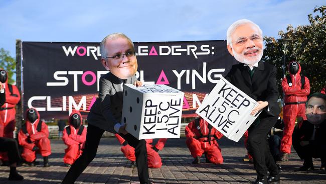 Climate change activists wearing masks depicting images of World leaders, including Australia's Prime Minister Scott Morrison and India's Prime Minister Narendra Modi, take part in a "Squid Game" themed demonstration near the Scottish Event Campus (SEC), the venue of the COP26 UN Climate Change Conference in Glasgow.