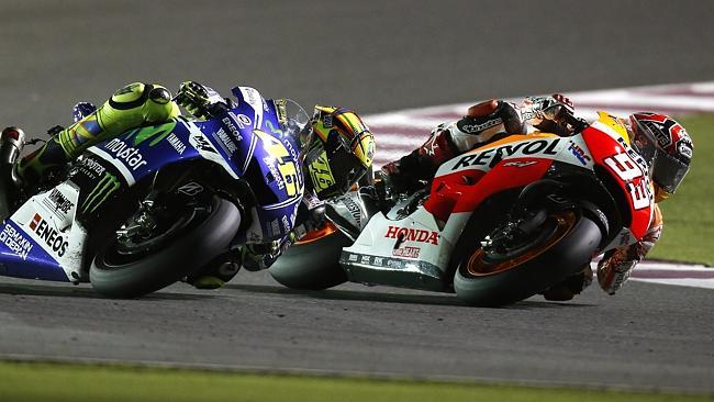 Marquez sweeps into the lead after Rossi runs wide.