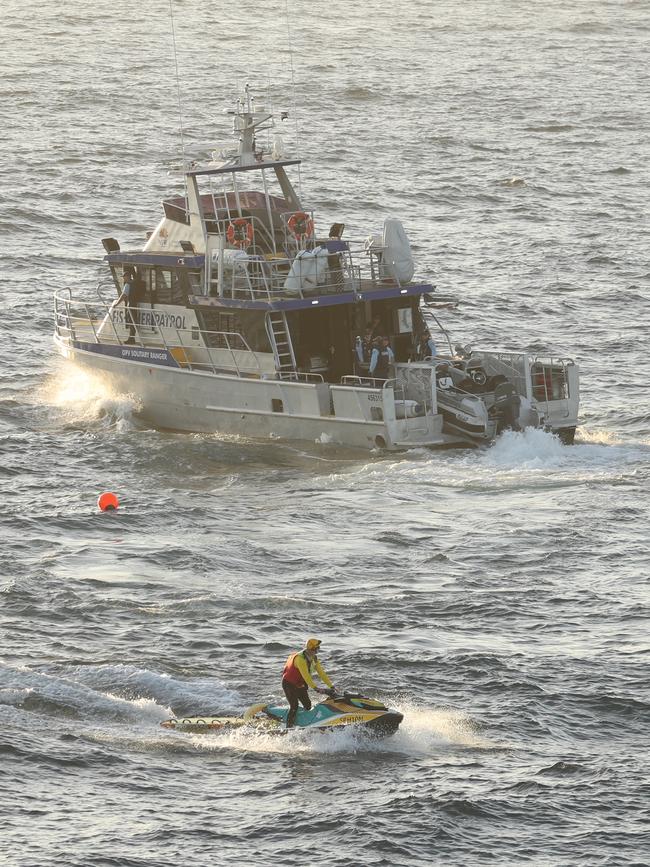 NSW Fisheries, police along with life savers scour the water on Thursday. Picture: John Grainger