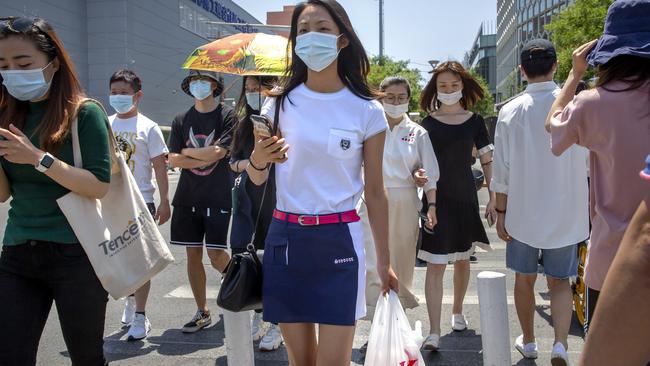 People wear face masks to protect against the coronavirus as they walk across an intersection in Beijing, Friday, June 5, 2020. Picture: AP