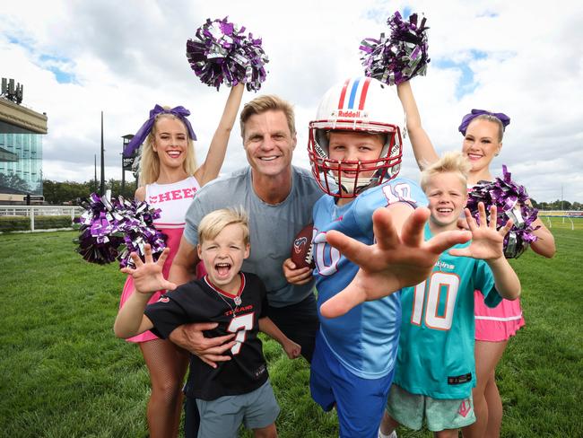 NFL super fan Nick Riewoldt – pictured with sons James, Will and Teddy, and cheerleaders Kelsey Jenning and Ashleigh Kempster – can’t wait to attend Caulfield Racecourse’s Super Bowl Monday party as part of an NFL-themed summer racing carnival. Picture: David Caird