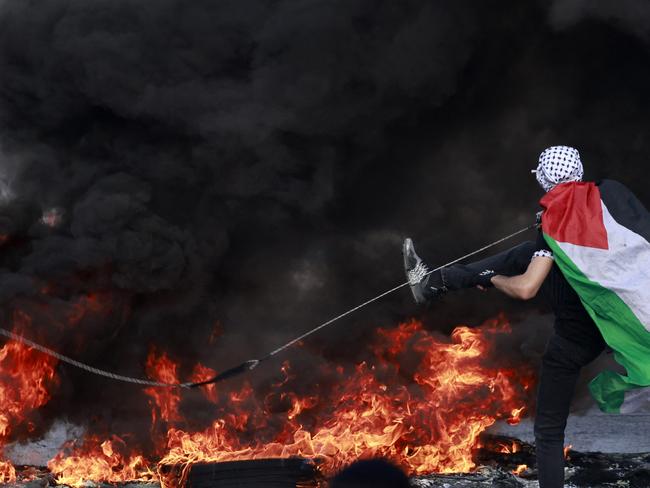 A Palestinian uses a slingshot during clashes with Israeli soldiers in the occupied West Bank. Picture: AFP