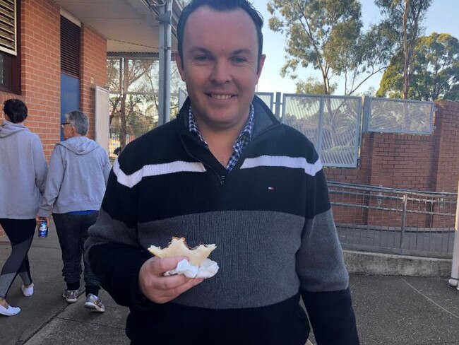 A man trying a sausage