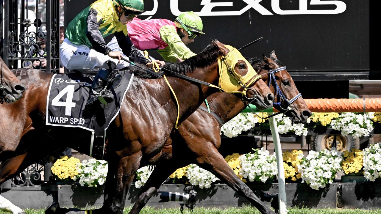 Knight's Choice ridden by Irish jockey Robbie Dolan hits the line to win ahead of Japanese horse Warp Speed ridden by jockey Akira Sugawara. Photo by William WEST / AFP.