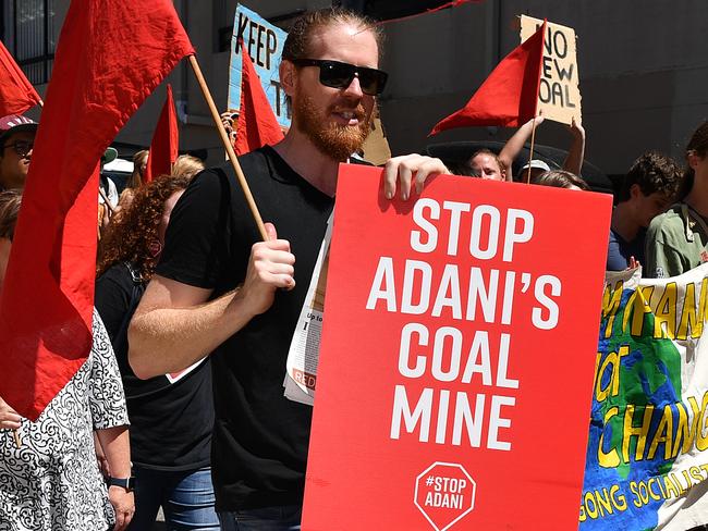 Inner west residents from Stop Adani Sydney hold placards as they march during a rally at Camperdown in Sydney, Sunday, February 17, 2019. (AAP Image/Joel Carrett) NO ARCHIVING