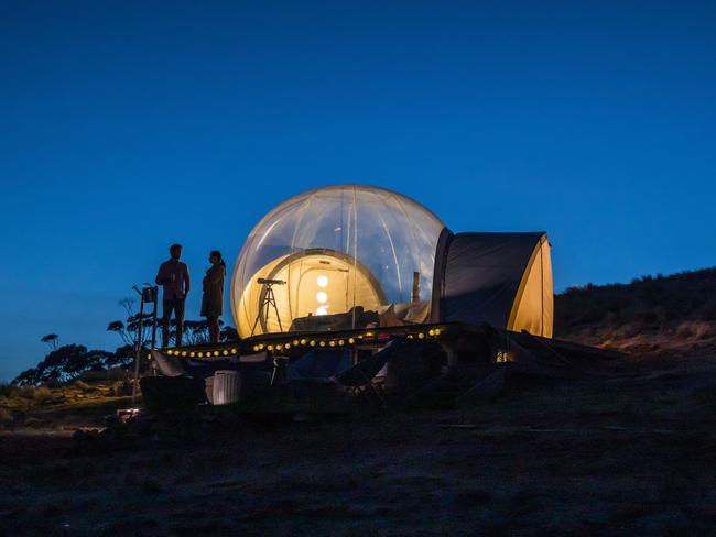 ESCAPE:  Couple relaxing in their Bubbletent Australia accommodation in the Capertee Valley. Picture: Destination NSW