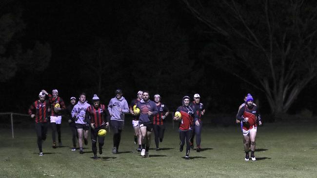 Running laps to warm up in the cold conditions. Picture: Sarah Reed.