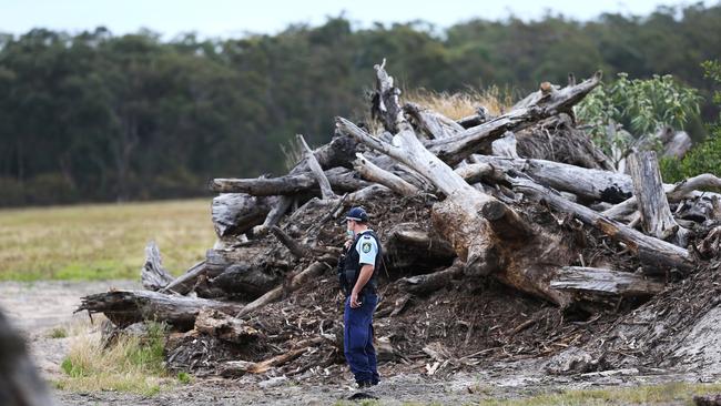 Police at the scene of a burnt out car near Heatherbrae, about 20km away from where the man‘s body was found in Salt Ash. A homicide investigation has been launched after the man was found dead with a head injury. Picture: NCA NewsWire / Peter Lorimer