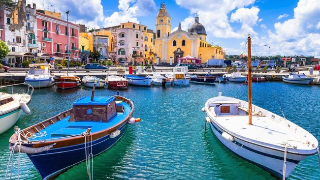 Colourful boats and houses on the island of Procida in Campania, Italy.