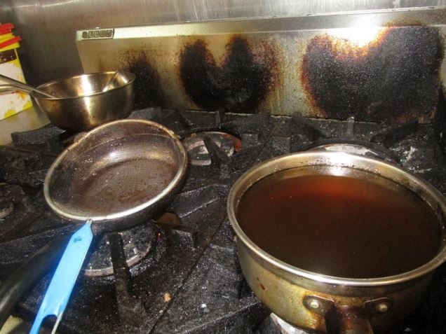 Grease and heavily carbonised material on top of a gas stove top. Picture: Brisbane City Council