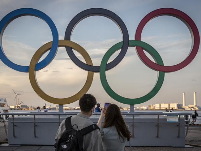 YOKOHAMA, JAPAN - JULY 22: People take photographs of Olympics rings on July 22, 2021 in Yokohama, Japan. Olympics opening ceremony director, Kentaro Kobayashi, has been sacked on the eve of the event after footage emerged in which he appeared to make jokes about the Holocaust. Mr Kobayashi follows a number of other figures involved in the Tokyo Olympic Games who have had to step down for inappropriate remarks. (Photo by Yuichi Yamazaki/Getty Images)