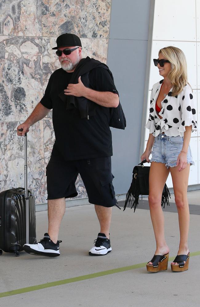 Shock radio host Kyle Sandilands and new girlfriend Tegan Kynaston leave Cairns after holidaying in tropical far North Queensland for a week with her parents. Picture: Mega Agency