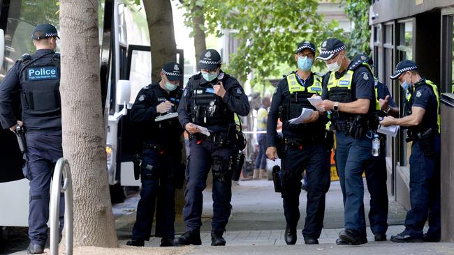 Police outside the Park Hotel in Carlton, where detained refugees caught the virus in October. Picture: Andrew Henshaw