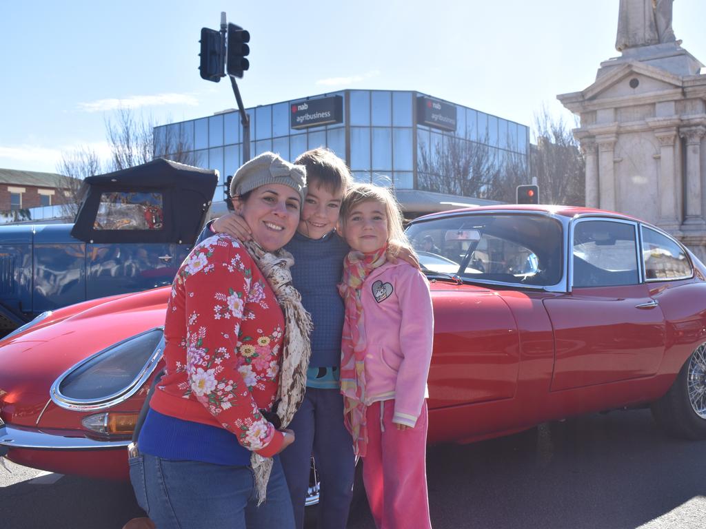 Silvana, Joshua, and Ava Malone with one of their favourite cars in the Jumpers and Jazz Grand Automobile Show on July 18, 2021.