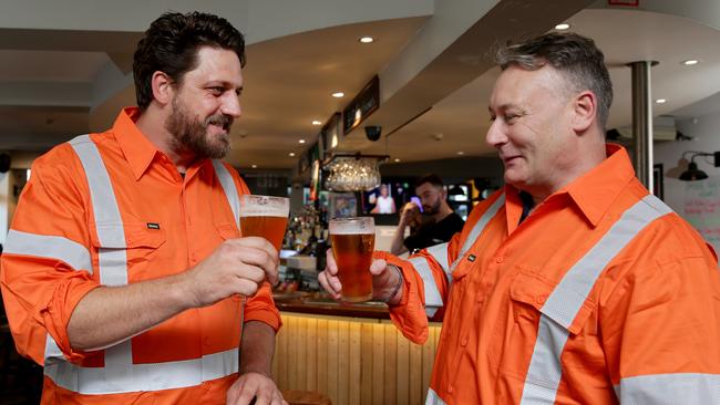 Steel worker Paul Heffron, right, enjoying a beer with Michael Willcocks. Picture: Jonathan Ng