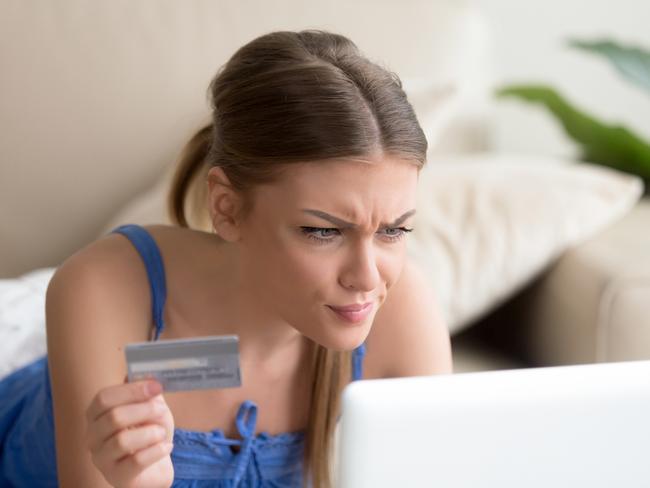 Confused young woman having problem with blocked credit card making rejected unsecure online payment using laptop at home, invalid expired account, transaction failed, money withdraw impossible, debt; ; banking errors and mistakes generic