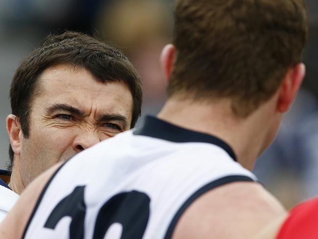 Chris Scott delivers a message to Steve Johnson in his last game for the Cats. Picture: Wayne Ludbey