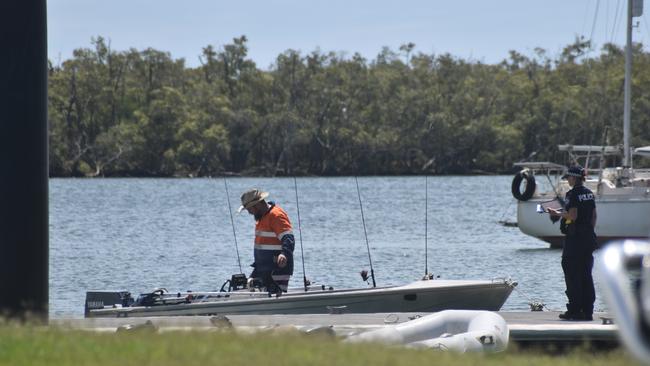 Police investigate the scene on the banks of the Burnett River and interview boaties following a serious boat crash.