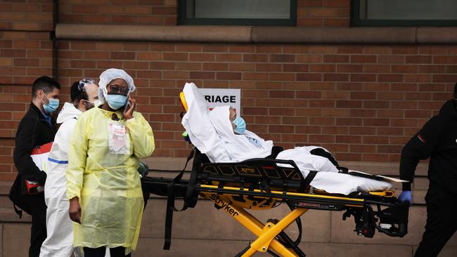 Medical workers take in a coronavirus patient at Maimonides Medical Centre in Borough Park, New York. Picture: AFP